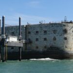 Historical Fort Boyard standing in the sea with a bright blue sky background.