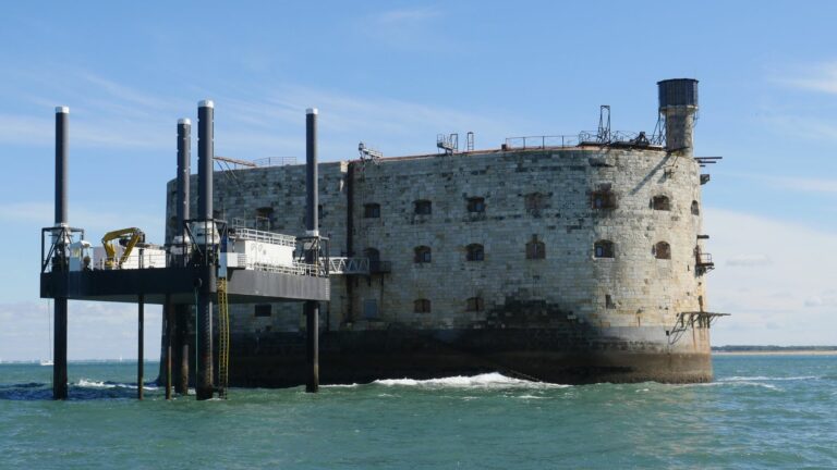 Historical Fort Boyard standing in the sea with a bright blue sky background.
